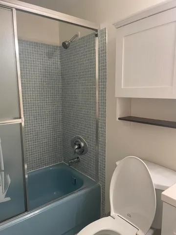 a bathroom with a toilet and a bathtub