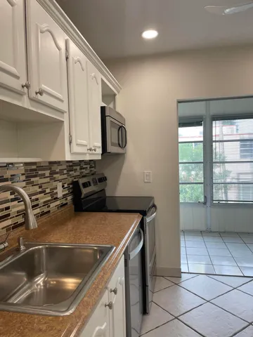 a kitchen with a sink and a stove top oven