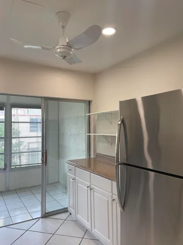 a metallic refrigerator freezer sitting in a kitchen