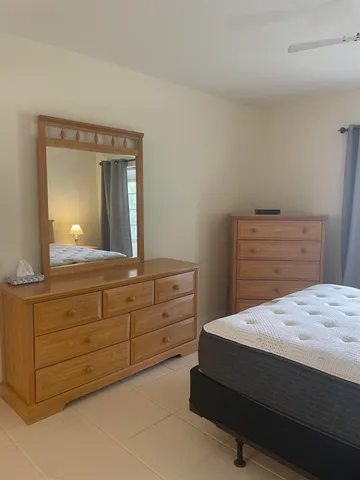 a bedroom with a bed and a dresser