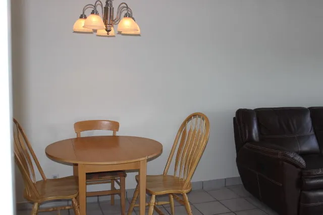 a dining room with furniture and a wooden floor