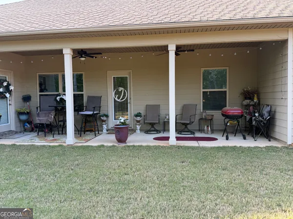 a view of a chairs and table in a patio