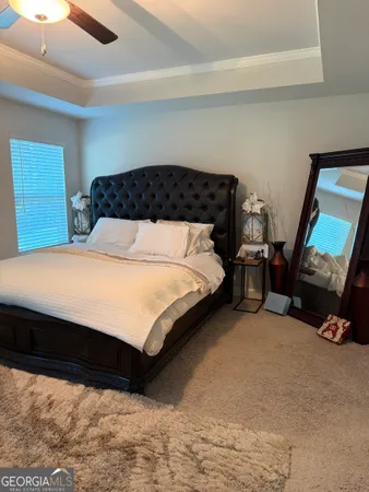 a bedroom with a bed and a mirror