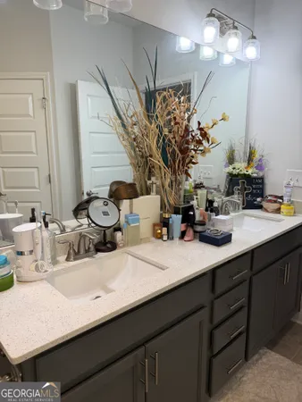 a bathroom with a sink double vanity and a mirror