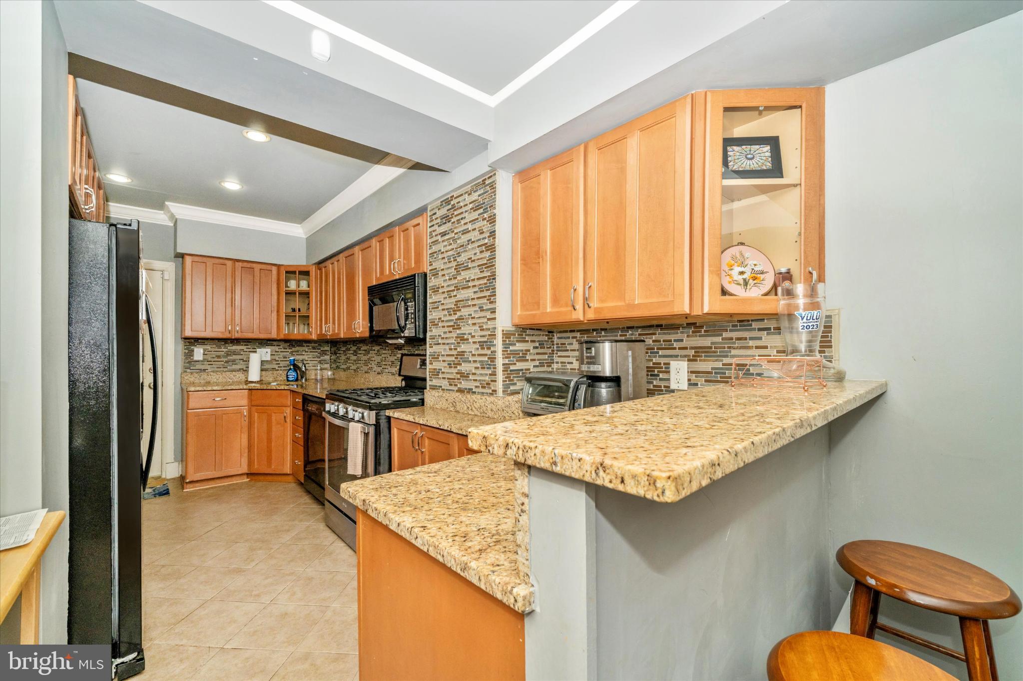 1221 William Street Baltimore, MD 21230 - Photo 11 of 44 a kitchen with stainless steel appliances granite countertop a sink stove and refrigerator