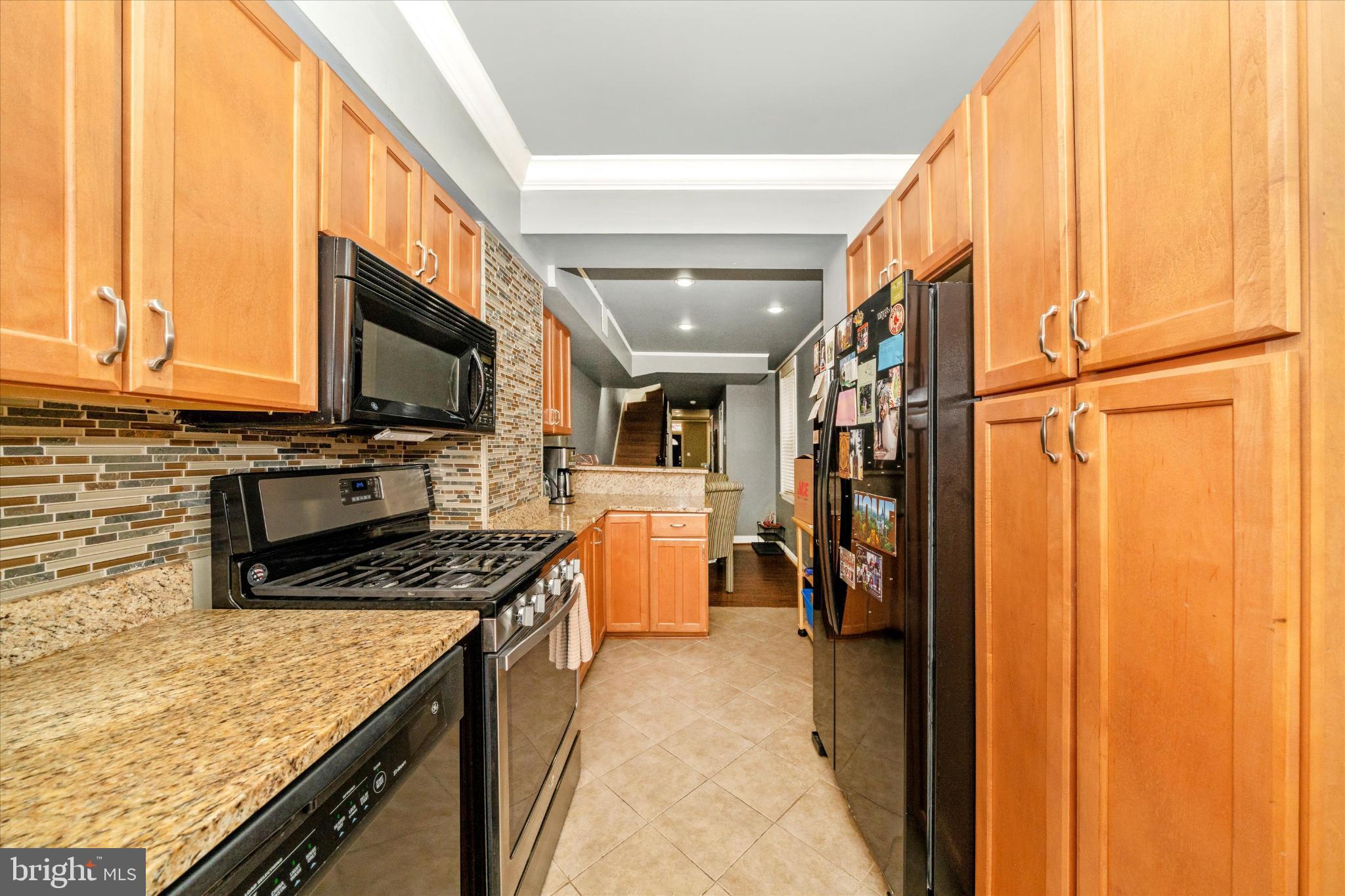 1221 William Street Baltimore, MD 21230 - Photo 13 of 44 a kitchen with stainless steel appliances granite countertop a refrigerator a stove and a microwave