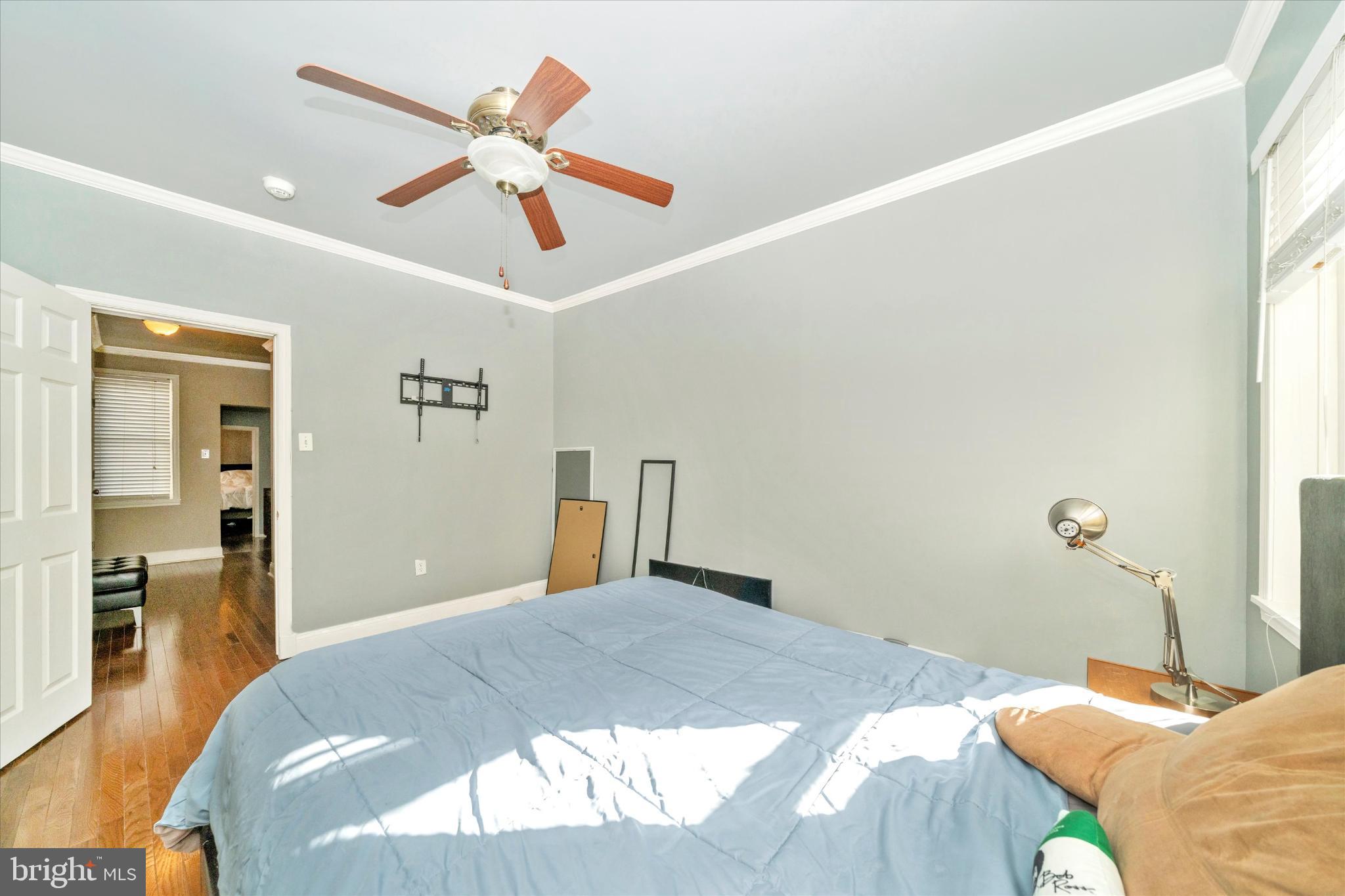 1221 William Street Baltimore, MD 21230 - Photo 19 of 44 a bedroom with a bed and a chandelier