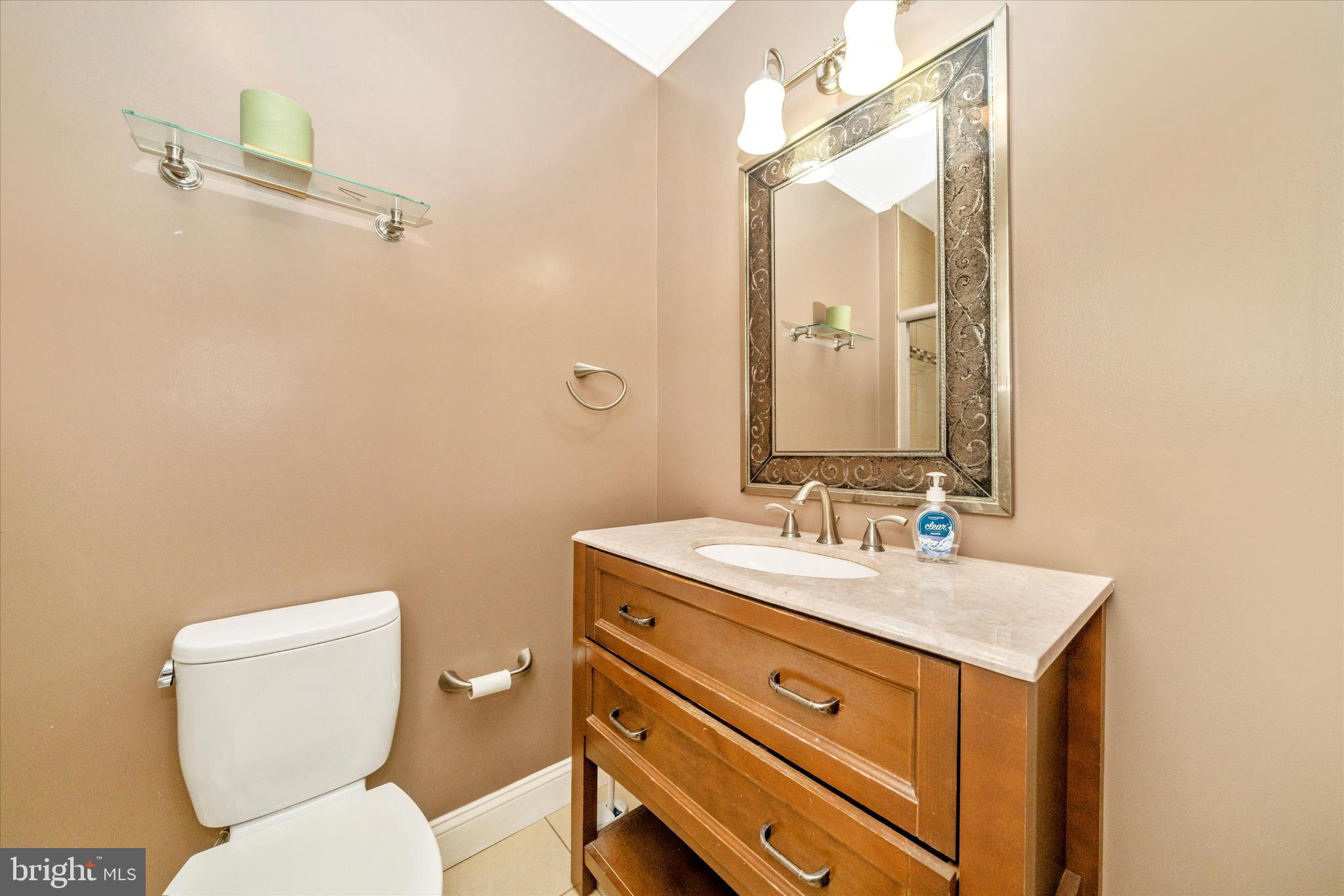 1221 William Street Baltimore, MD 21230 - Photo 27 of 44 a bathroom with a toilet sink and mirror