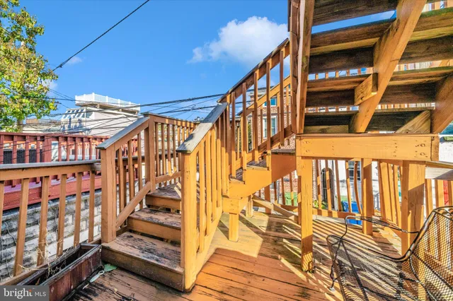 a view of balcony with wooden floor and fence