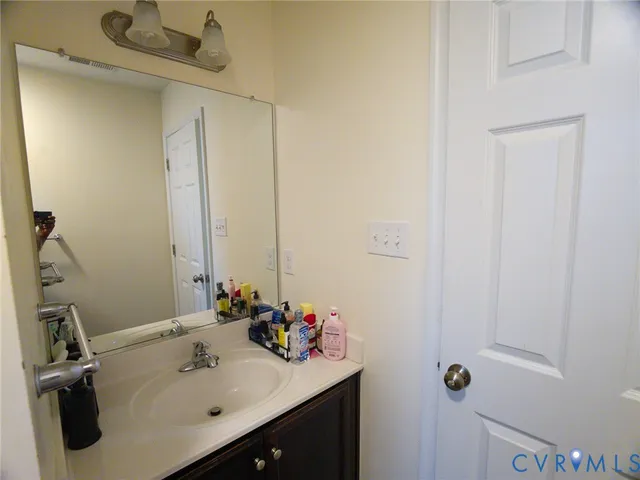 a bathroom with a sink vanity and tub