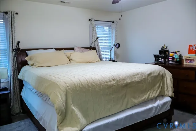 a bedroom with a bed and window