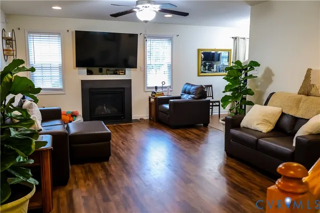a living room with furniture a flat screen tv and a fireplace