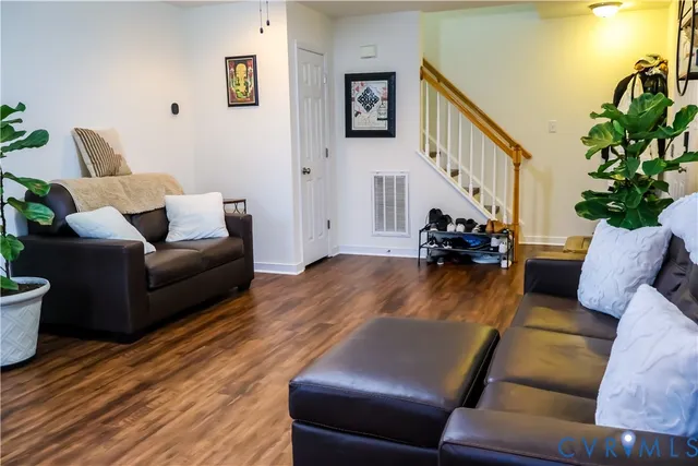 a living room with furniture and a potted plant