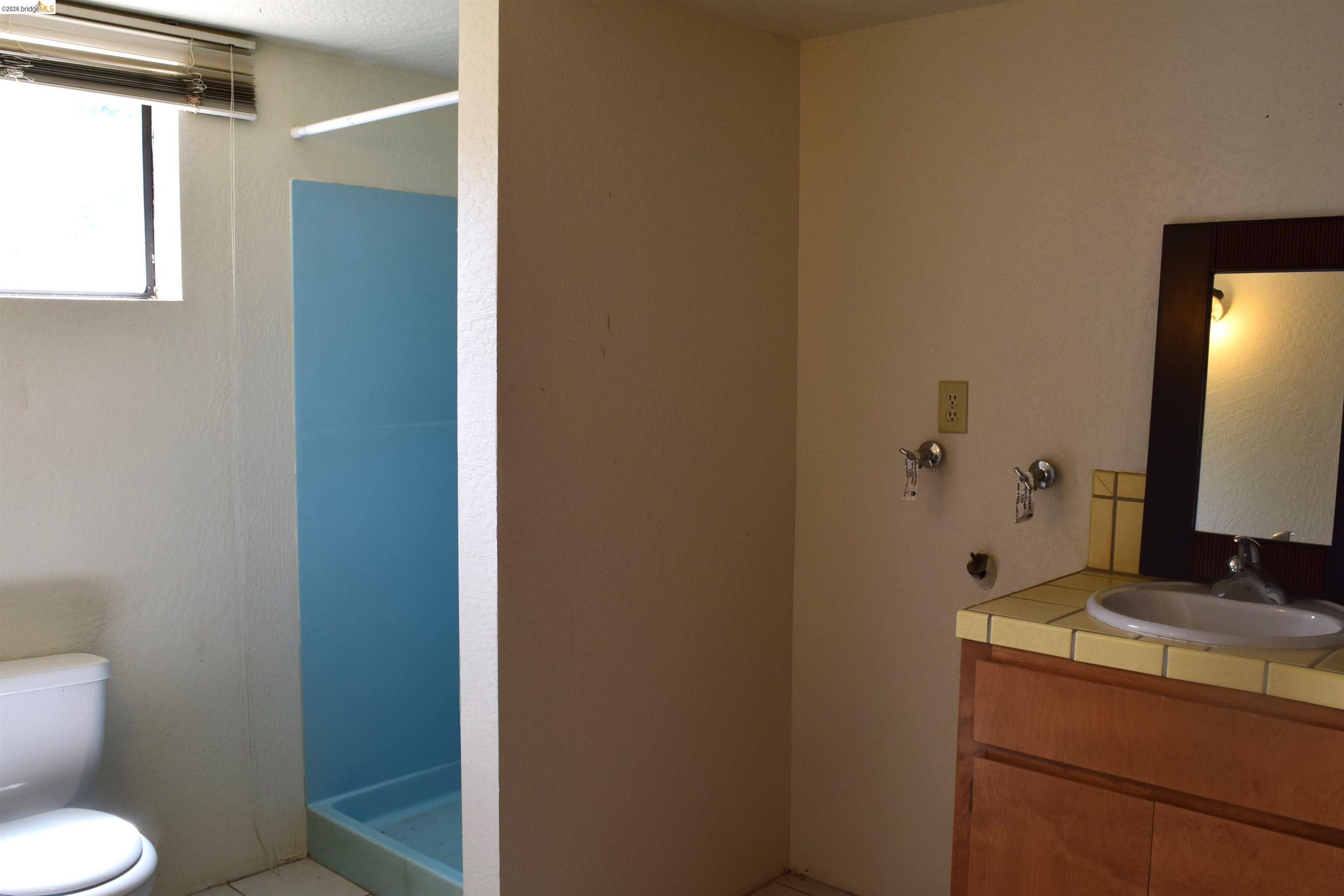 913 Quill Road Copperopolis, CA 95228 - Photo 19 of 55 a bathroom with a granite countertop sink toilet and mirror