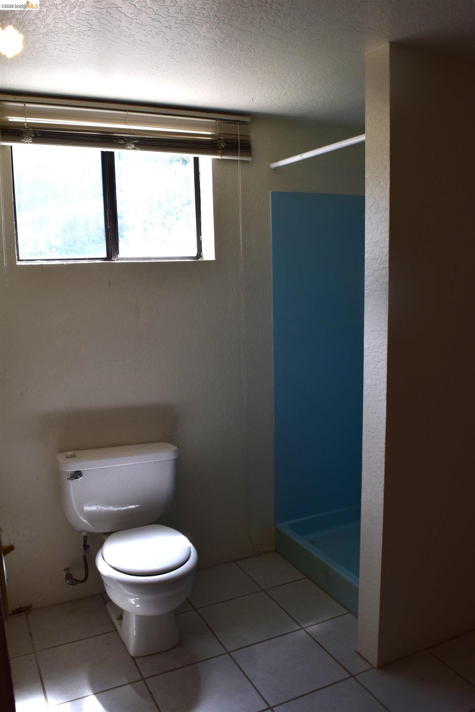 913 Quill Road Copperopolis, CA 95228 - Photo 20 of 55 a white toilet sitting in a bathroom next to a window