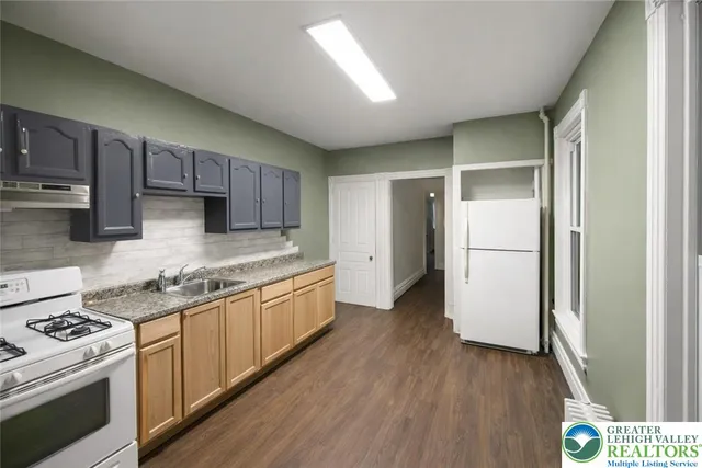 a kitchen with refrigerator a stove a microwave and cabinets