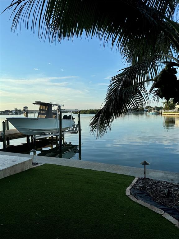 433 20th Avenue Indian Rocks Beach, FL 33785 - Photo 20 of 23 a view of a swimming pool with lawn chairs under an umbrella