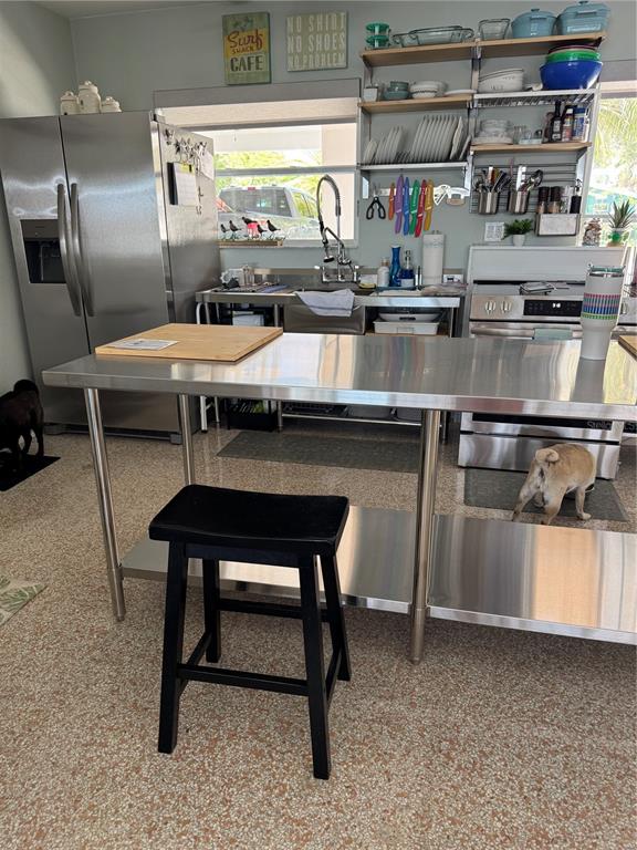 433 20th Avenue Indian Rocks Beach, FL 33785 - Photo 21 of 23 a kitchen with a sink cabinets and stainless steel appliances