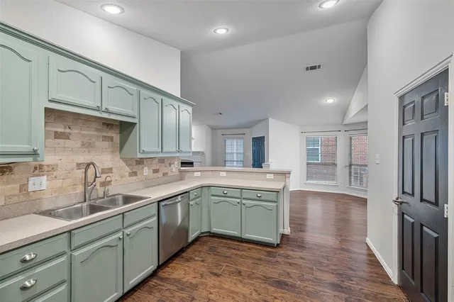 a kitchen with sink and cabinets