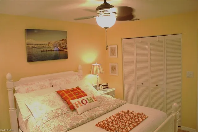 a bedroom with a bed and ceiling fan