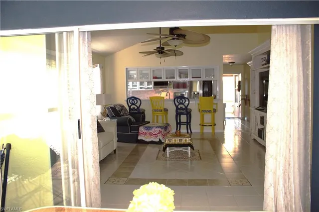 a view of a living room with furniture and floor to ceiling window