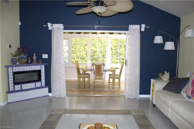 a view of a dining room with furniture a fireplace and chandelier
