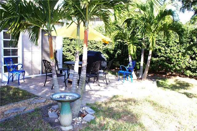 a view of a backyard with sitting area