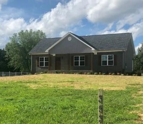 353 Lear Road Portland, TN 37148 - Photo 1 of 14 a house that has a big yard with large trees