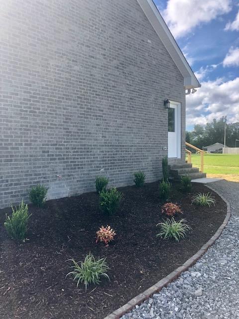 353 Lear Road Portland, TN 37148 - Photo 12 of 14 a view of a backyard with plants and chair