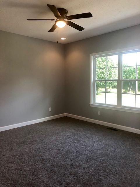 353 Lear Road Portland, TN 37148 - Photo 8 of 14 an empty room with a window and a ceiling fan