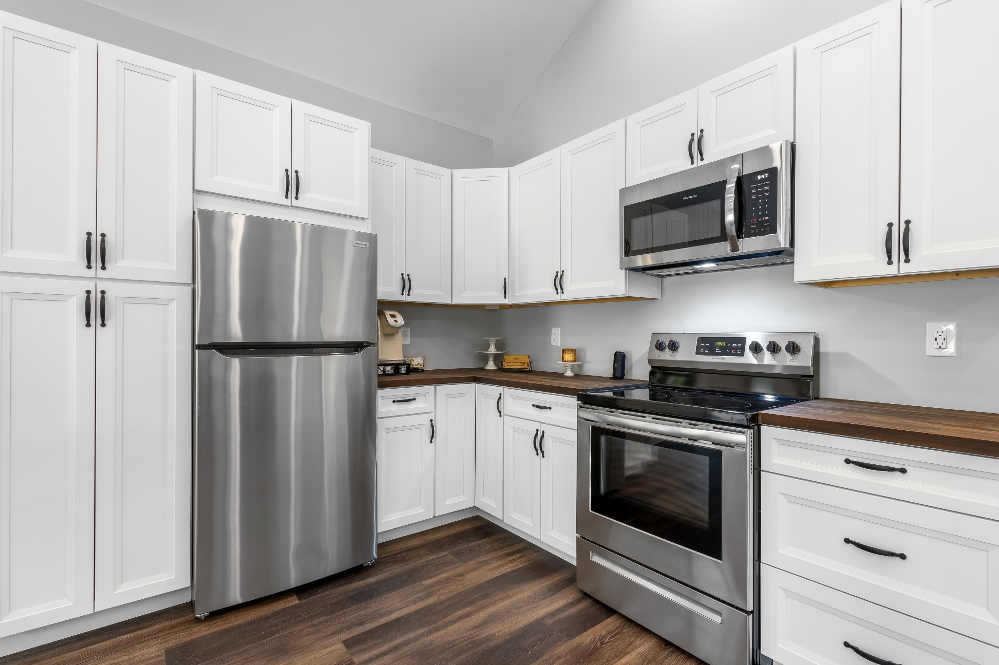 1049 Oregon Road Lascassas, TN 37085 - Photo 26 of 99 a kitchen with cabinets stainless steel appliances and wooden floor