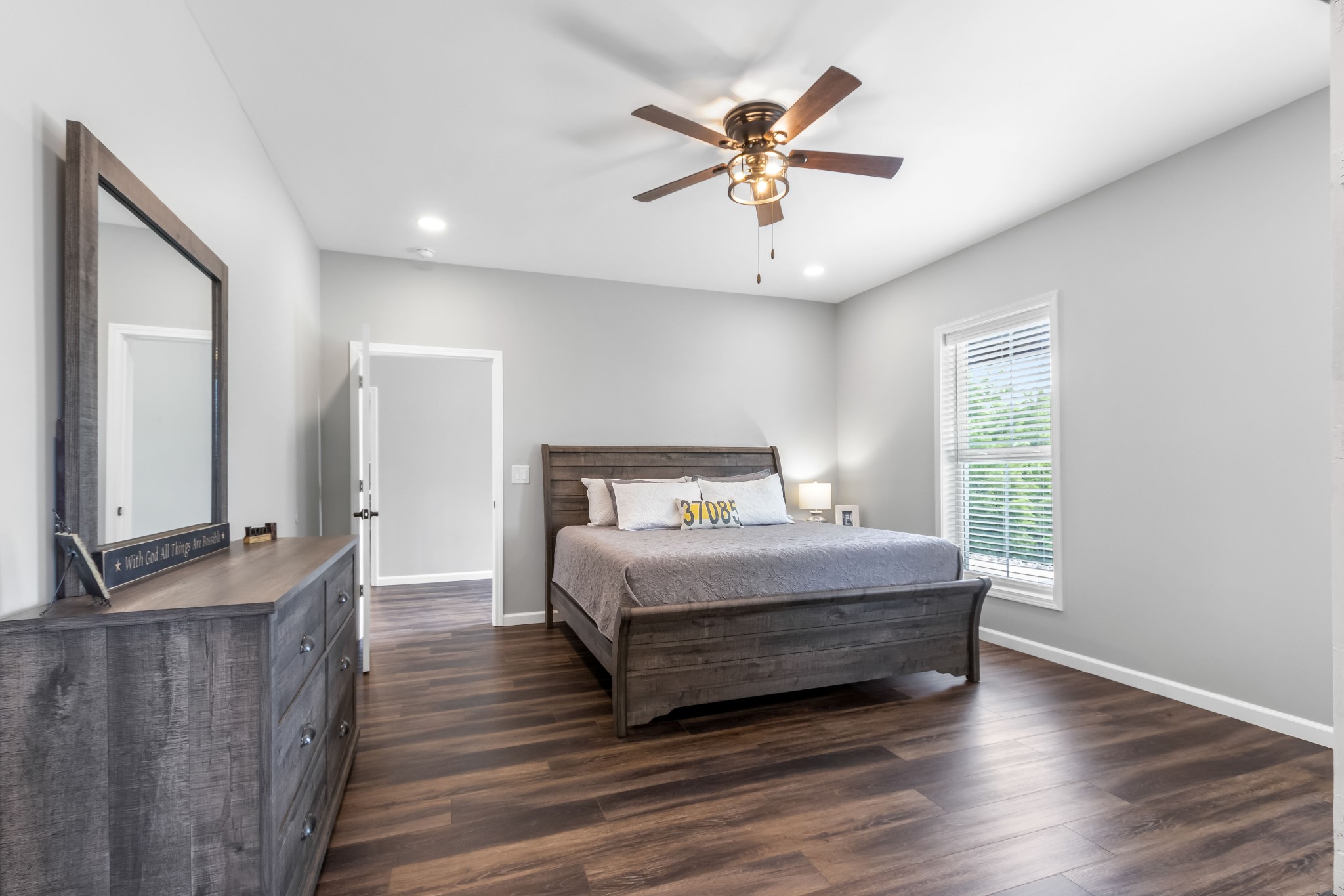 1049 Oregon Road Lascassas, TN 37085 - Photo 28 of 99 a bedroom with a large bed a chandelier and windows