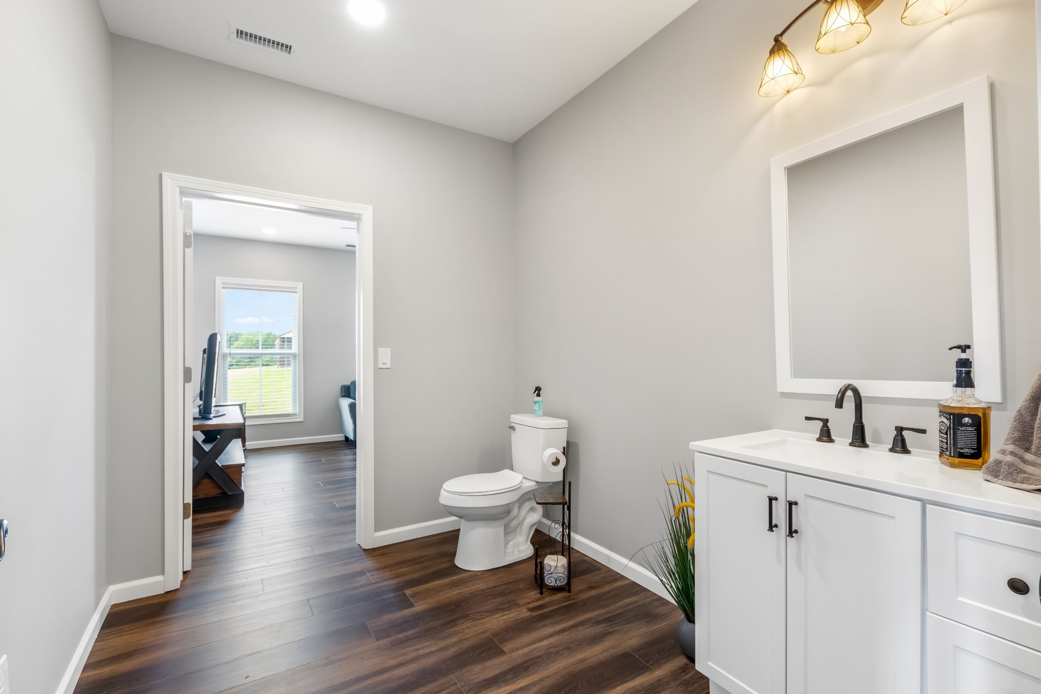 1049 Oregon Road Lascassas, TN 37085 - Photo 39 of 99 a bathroom with a sink toilet and a large mirror