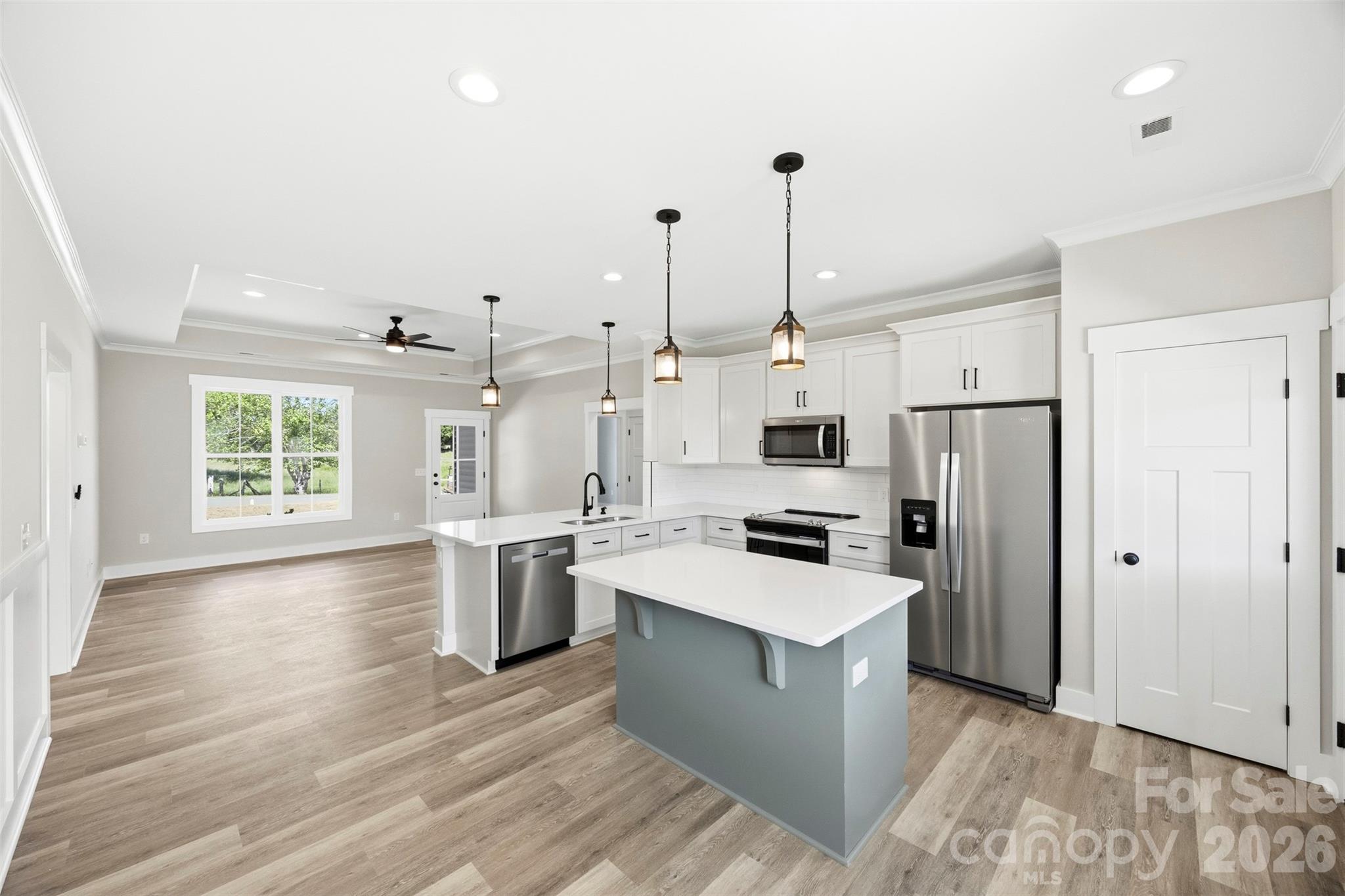 1014 Speight Road Albemarle, NC 28001 - Photo 10 of 28 a kitchen with a sink a counter top space stainless steel appliances and a window
