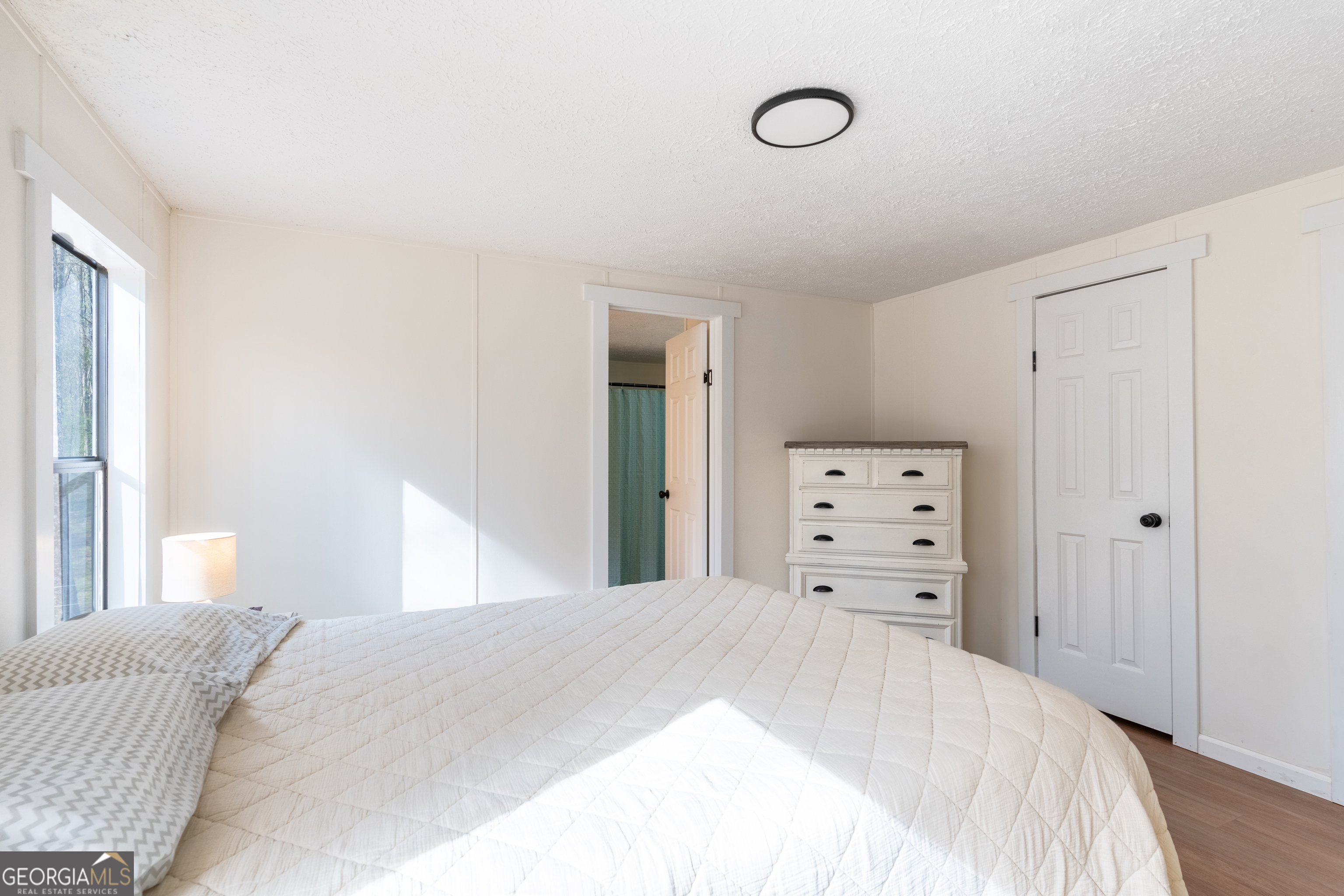452 Aikenton Road Monticello, GA 31064 - Photo 21 of 47 a bedroom with a bed and a dresser
