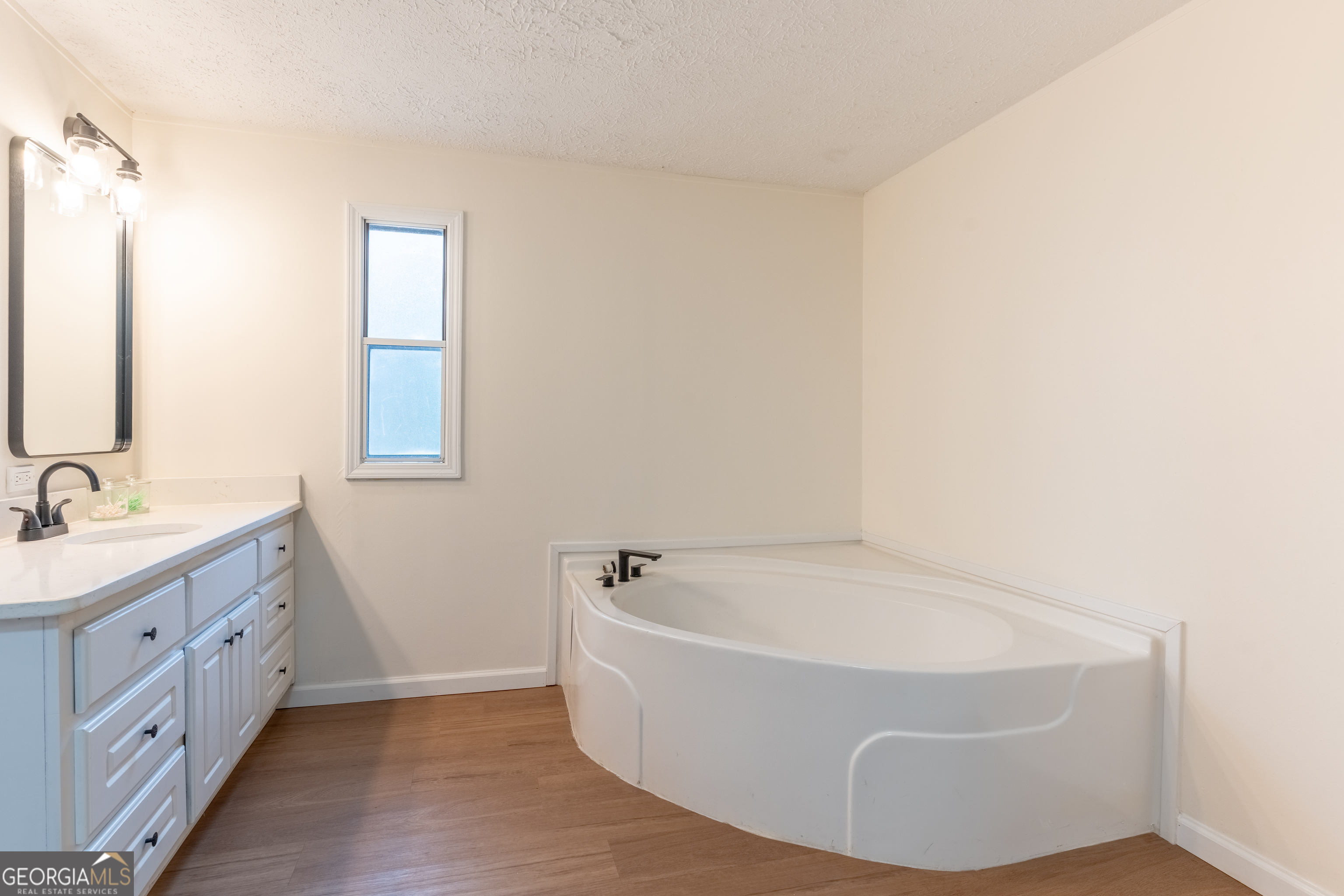 452 Aikenton Road Monticello, GA 31064 - Photo 23 of 47 a white bath tub sitting in a bathroom