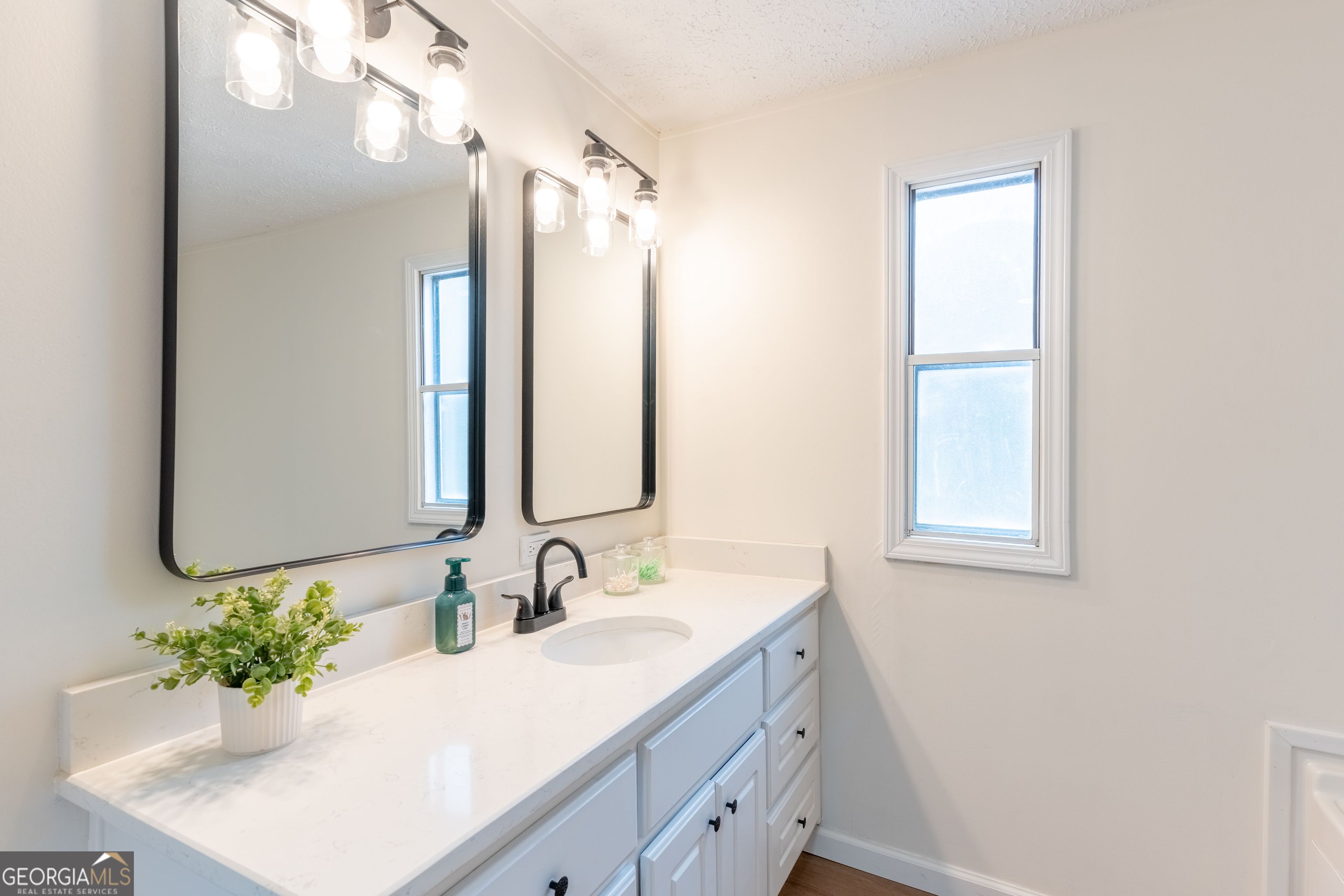452 Aikenton Road Monticello, GA 31064 - Photo 25 of 47 a bathroom with a sink vanity granite and a mirror