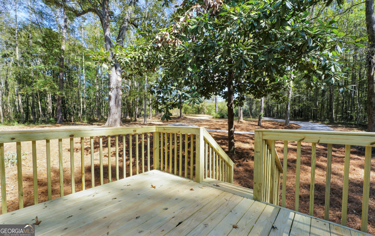 452 Aikenton Road Monticello, GA 31064 - Photo 32 of 47 a view of balcony with wooden floor and fence