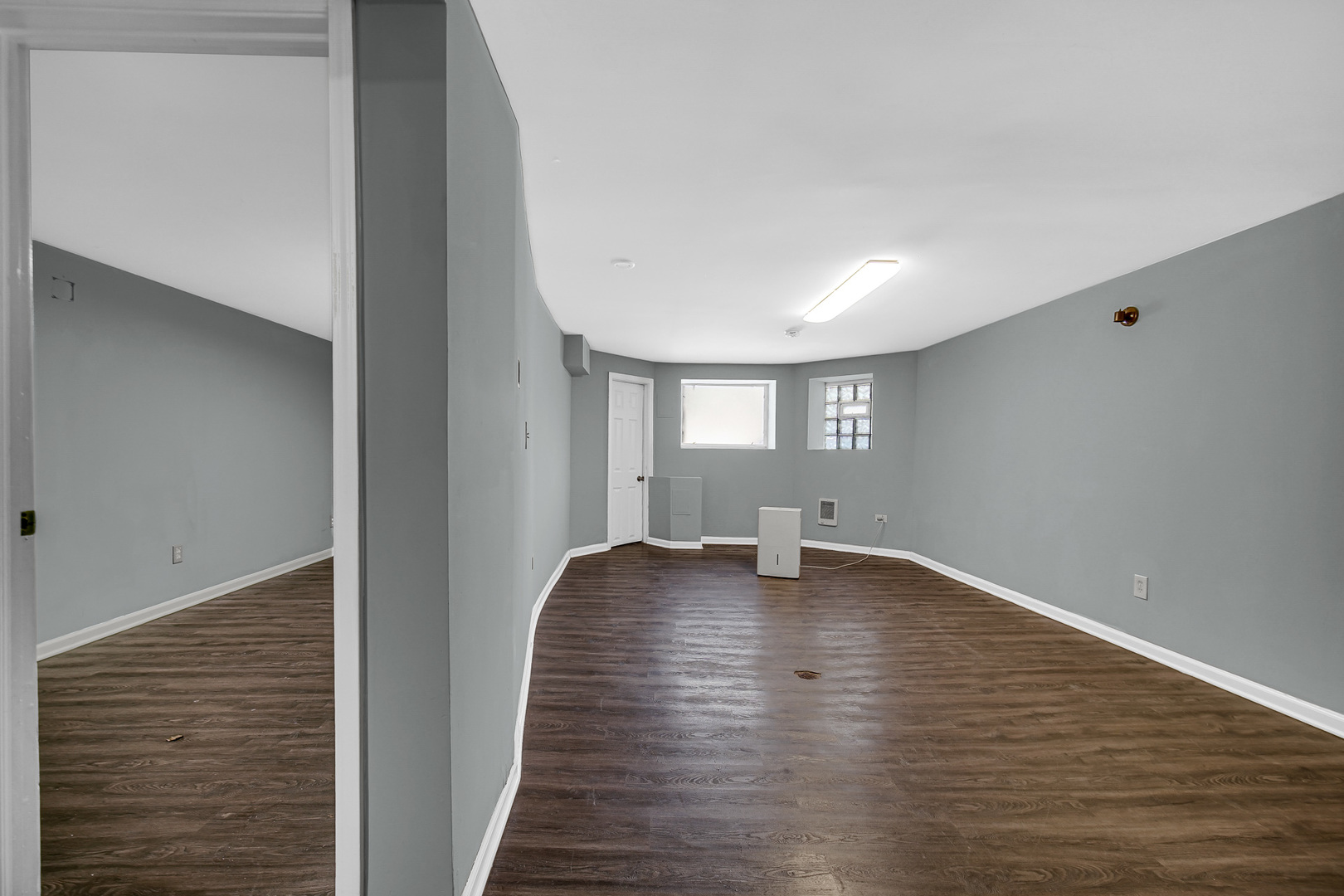 5540 South Honore Street Chicago, IL 60636 - Photo 15 of 23 a view of an empty room with wooden floor and a window
