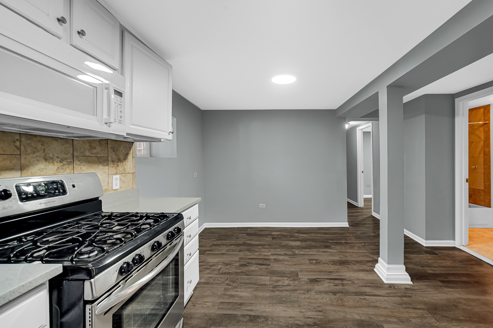 5540 South Honore Street Chicago, IL 60636 - Photo 20 of 23 a kitchen with granite countertop a stove and a refrigerator