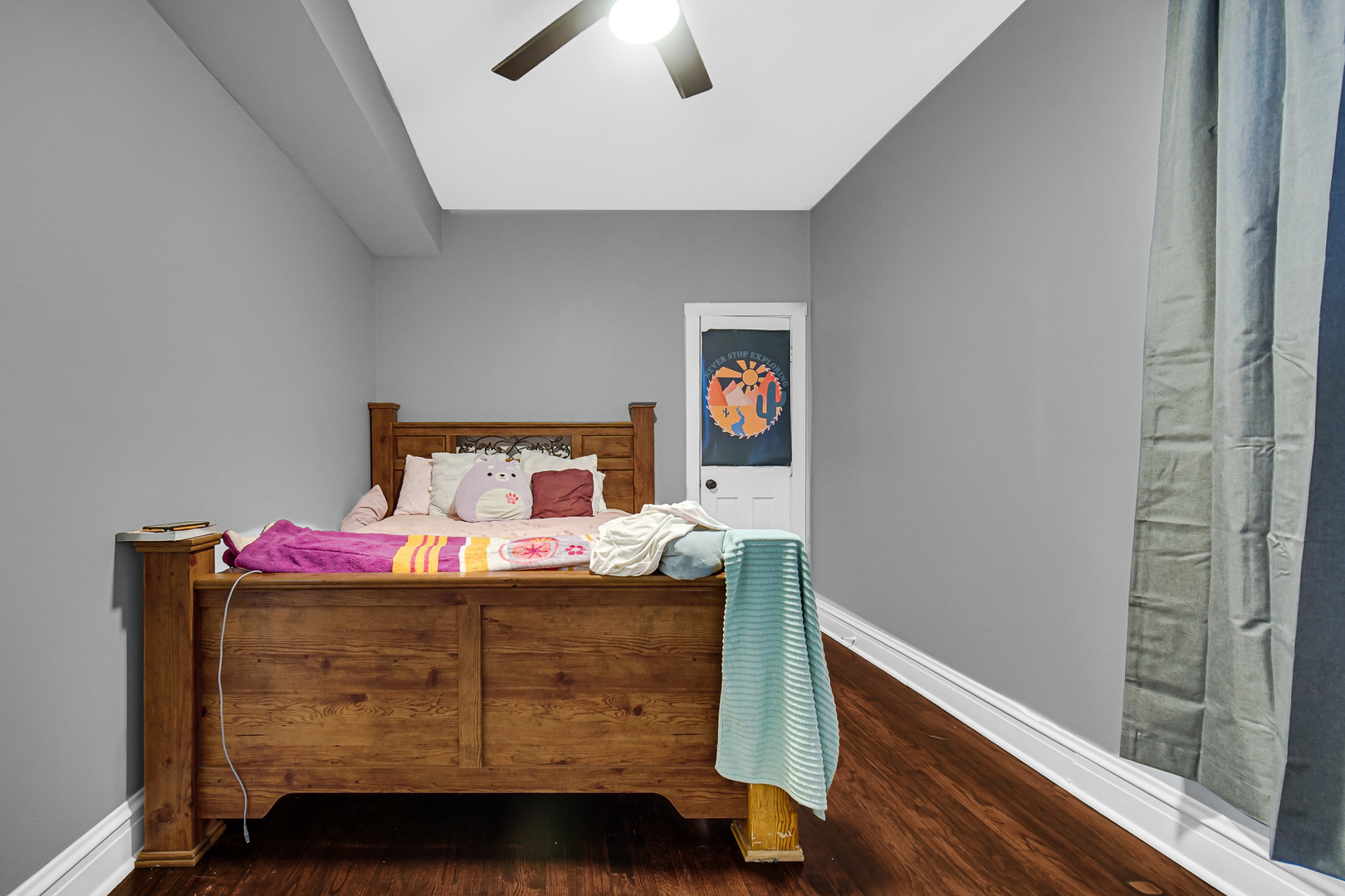 5540 South Honore Street Chicago, IL 60636 - Photo 5 of 23 a bedroom with a bed and a chandelier