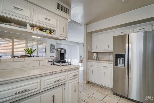 a kitchen with stainless steel appliances white cabinets and a sink