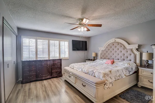 a bedroom with a large bed and a chandelier