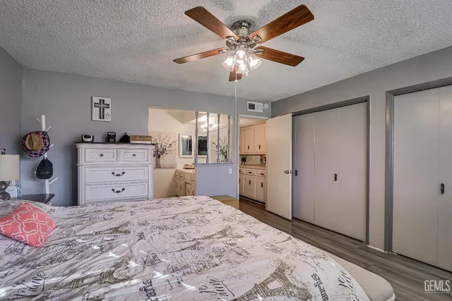 a large bedroom with a bed and a chandelier