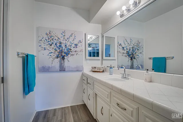 a bathroom with a double vanity sink mirror and shower
