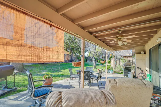 a view of a patio with table and chairs potted plants with a large tree