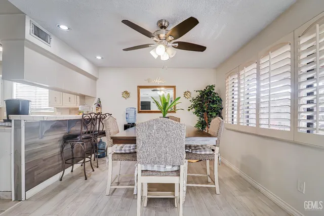 a view of a dining room with furniture and wooden floor