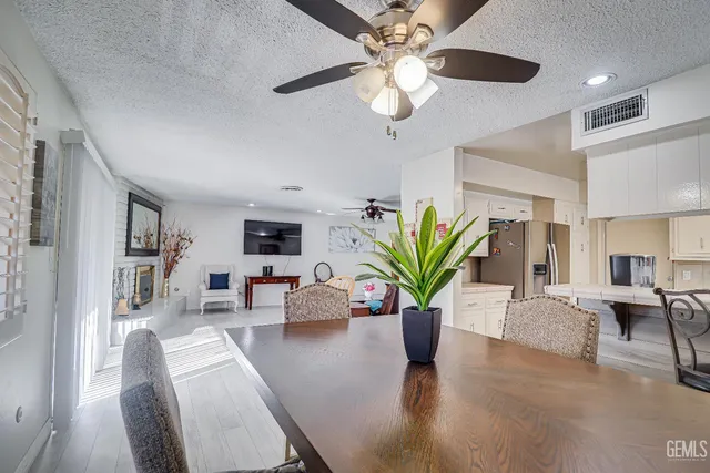 a living room with furniture potted plant and a chandelier