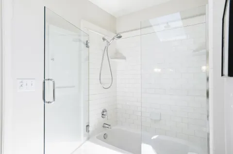 a bathroom with a shower and a shower