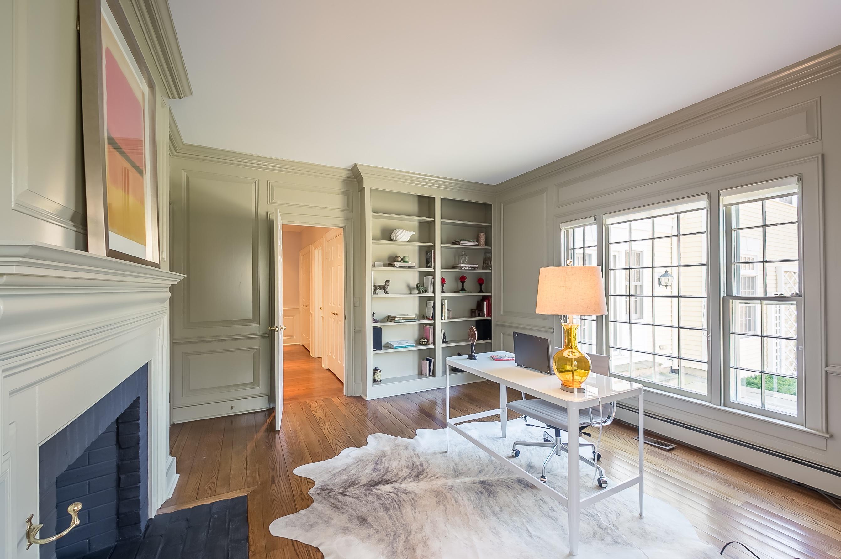 Undisclosed Address Wilton, CT 06897 - Photo 9 of 30 a living room with furniture a fireplace and a large window